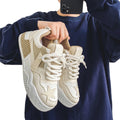 Beige men's canvas sneakers in a lifestyle setting.