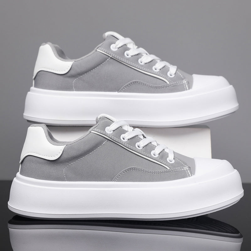 Side profile of men's casual platform skate sneakers in a clean urban setting.