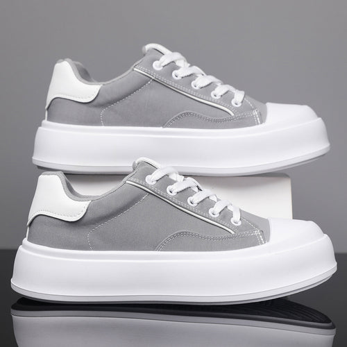 Side profile of men's casual platform skate sneakers in a clean urban setting.