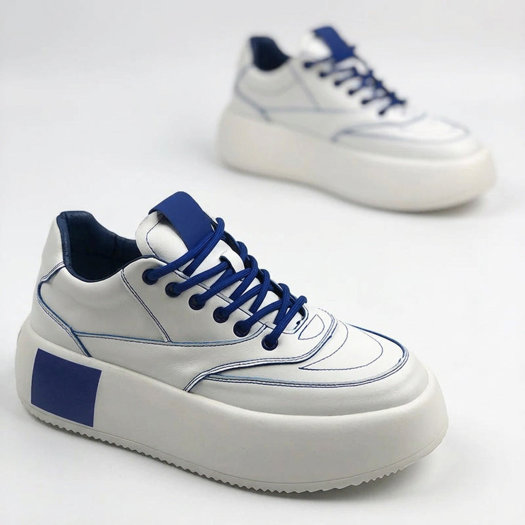 Side profile view of men's thick sole casual sports shoes in a modern urban setting.